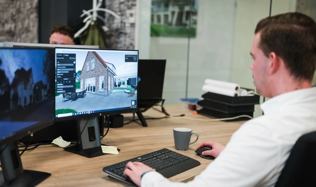 Modelleur maakt een 3D ontwerp van een villa op de computer