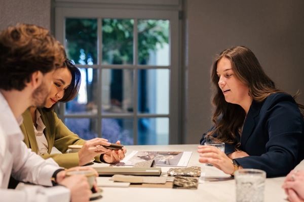 Interieurarchitect bekijkt interieurstalen samen met klant aan tafel